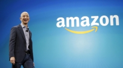 FILE - In this June 16, 2014, file photo, Amazon CEO Jeff Bezos walks onstage for the launch of the new Amazon Fire Phone, in Seattle. Amazon has had a complicated few weeks with its cancellation of a New York headquarters Thursday, Feb. 14, 2019, and extortion claims last week related to intimate photos taken by its founder. Experts say the events are unlikely to pose much of a threat to Amazon’s business. But the company will continue to face more challenges as it grows larger. (AP Photo/Ted S. Warren, File)